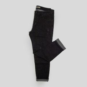 a pair of black jeans sitting on top of a white floor